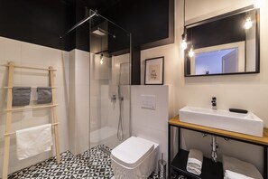 Bright bathroom with washing machine and shower cabin. 