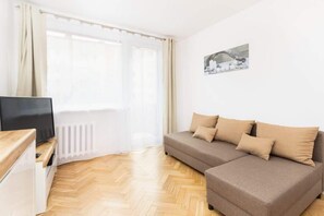 The cozy living room featuring a comfy sofa perfect for relaxing after a day of exploring the city.