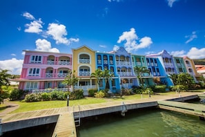 The condo is the entire middle floor of the pink building on the left hand side
