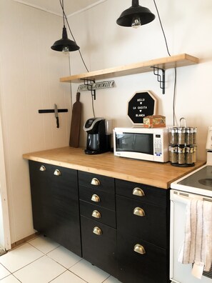 Kitchen with microwave, keurig and spice rack