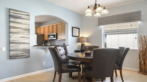 Enjoy cozy meals in this charming dining nook, beautifully lit and elegantly styled for a warm, welcoming feel.