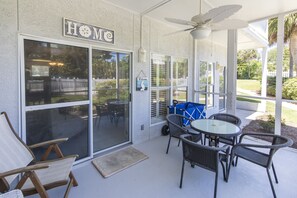 Screen porch with table and chairs