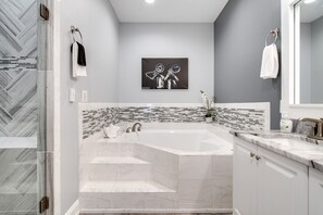 Pamper yourself in Bathroom 2 with his and hers sinks and a lavish bathtub!