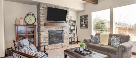 Family room featuring fire place and large flat screen tv