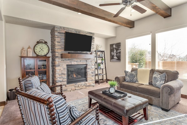 Family room featuring fire place and large flat screen tv