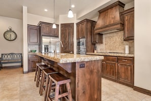 Fully stocked gourmet Kitchen featuring granite countertops