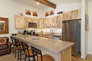 Enjoy a coffee, glass of wine or afternoon snack at the breakfast bar.  The fully stocked kitchen meets all your cooking needs!