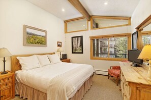 The master bedroom, with vaulted ceilings, features a king bed, flat screen TV and en-suite bath.