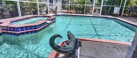 Screened-in patio pool with remote spa.  No dunking Arney the alligator!