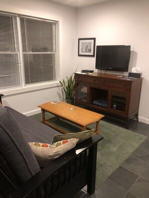 Living room area.  Queen size futon.  Cable TV (with Netflix).  Slate flooring.