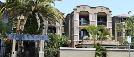 Street view of the complex - unit is directly behind the palm tree & main gate.