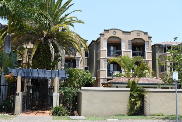 Street view of the complex - unit is directly behind the palm tree & main gate.