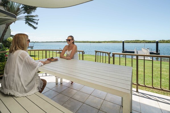 Relax in the alfresco area by the lush grass and river.