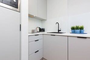 The fully equipped kitchenette includes everything you need for a home-cooked meal.