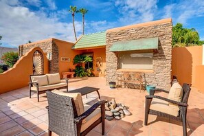 Backyard patio with sun loungers, hot tub, gas chiminea, and BBQ
