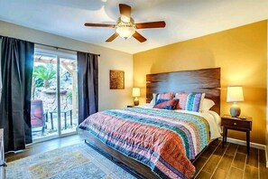 Master bedroom w/ King size bed and exit to backyard patio