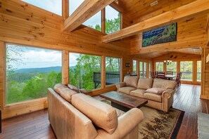 Main level living room with wood-burning fireplace and beautiful mountain views