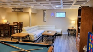 basement hang out space with TV/DVR/Pool table/Pub height table