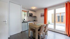 Prepare meals in the kitchenette and enjoy them at the dining table.