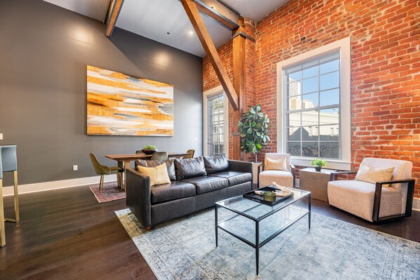 Open concept living, kitchen, and dining area with comfortable seating for you and your guests. 65” Samsung Smart 4K TV for streaming apps and DIRECTV. Sofa converts to a queen-size sleeper. Dining table for four. Lots of natural light!
