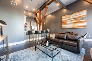 Open concept living, kitchen, and dining area with comfortable seating for you and your guests. 65” Samsung Smart 4K TV for streaming apps and DIRECTV. Sofa converts to a queen-size sleeper. Dining table for four. Lots of natural light!