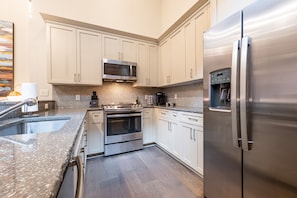 Cook and dine easily in the fully stocked kitchen, equipped with all stainless steel appliances, gas range, basic cookware, and a dining area for a comfortable meal at home. Entertain at the bar with seating for four.