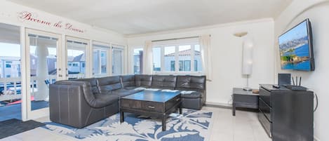 Spacious living and dining areas open up to the front balcony of this upper 4 bd/2 ba ocean view unit.