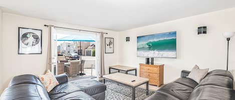 Living room looks out to front ocean view patio, with easy access through sliding glass doors.