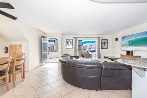 View of main living spaces from the front entry. Open floor plan between living, kitchen and dining areas.
                