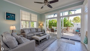 Double sets of french doors off the living area open to the private outdoor porch...