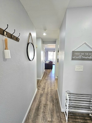 Hallway to the kitchen, living/dining room and balcony