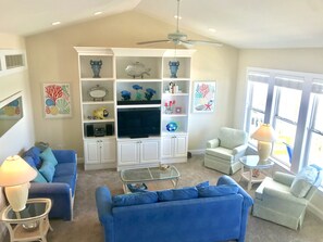 Colorful living room and vaulted ceilings sure to put you on "beach time!" 