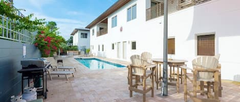 Pool/hot tub/grill station on travertine flooring.  