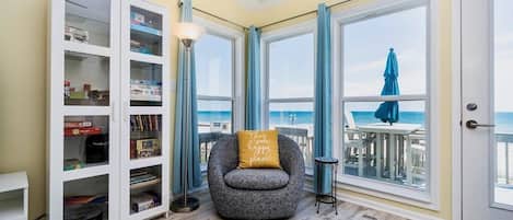 Living room with cozy swivel chair; see the ocean from inside as well as out.