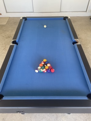 Under the table tennis table is a pool table.. adults to supervise 