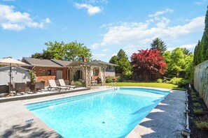 Stunning full sized pool with large deck and outdoor dining space.