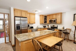 Brand new countertops and stainless steel appliances have been added to the functional kitchen area.