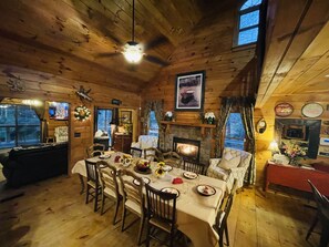 Open-concept dining room with fireplace and lounge over-looking the water