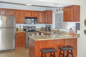 Well stocked kitchen with stove, fridge/freezer, microwave and dishwasher