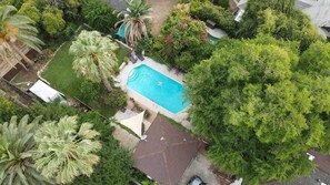 Aerial view of our property. Guesthouse's brown square roof, bottom center.