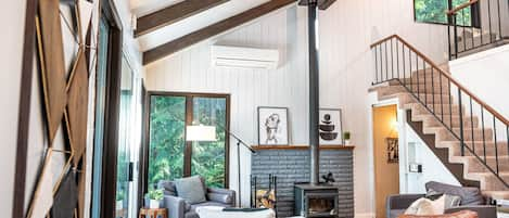 Tall ceiling with wood beams throughout. Walls of windows show off the PNW vibe 