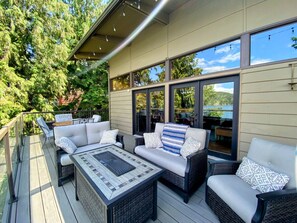 Host gatherings on the large deck, equipped with comfortable seating and a fire table.