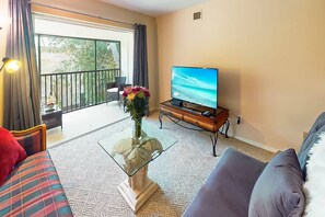 Living room with stacked sliders that open out to your screened lanai.  New Smart TV, WiFi included.