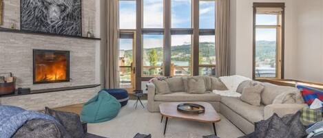 Main Livingroom with Floor to Ceiling Windows and Balcony Access