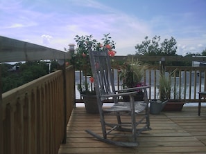 A bulkhead stairway leads to a casual deck shared with neighbors.