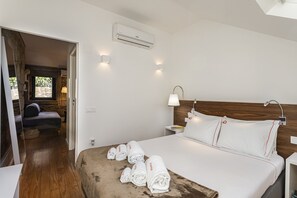 Double bed in room with wooden parque