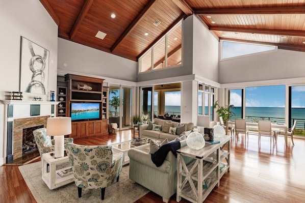A spacious, open-concept living area offers spectacular views of the gulf