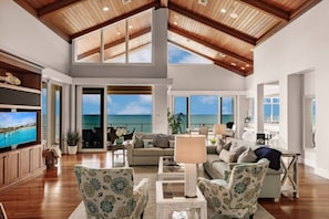 A spacious, open-concept living area offers spectacular views of the gulf