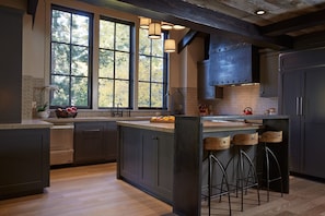 The kitchen: high ceilings, huge windows overlooking the forest