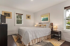 King size bed with views of the historic fig tree on the property.